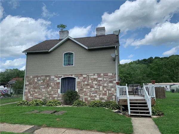 a front view of a house with a yard