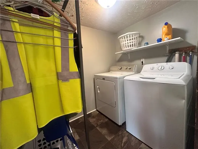 a view of a house with a big yard and a large tree