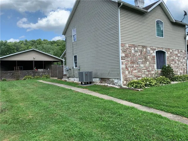 a front view of house with yard and green space