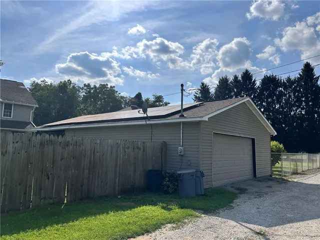 a backyard of a house with lots of green space and fountain
