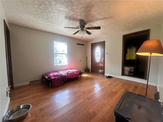 a view of a livingroom with furniture and a ceiling fan