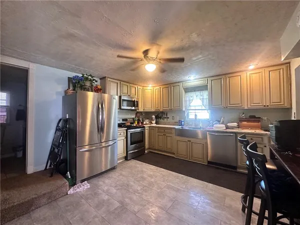a kitchen with refrigerator cabinets and wooden floor