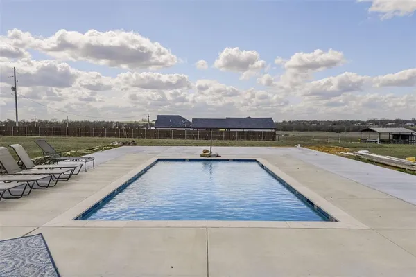 a view of swimming pool with furniture