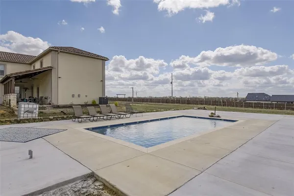 a view of a swimming pool with a lounge chair