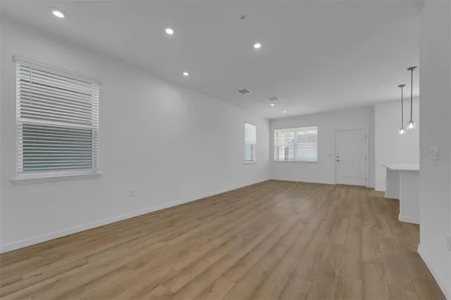 a view of empty room with wooden floor