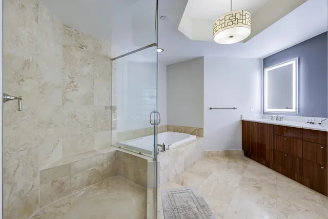 a spacious bathroom with a granite countertop sink a toilet and bathtub
