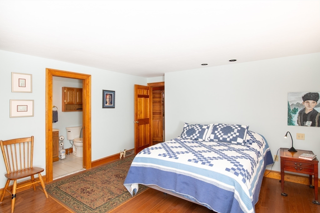 663 Wareham Street, Unit 8 Middleboro, MA 02346 - Photo 13 of 27 a bedroom with a bed and wooden floor