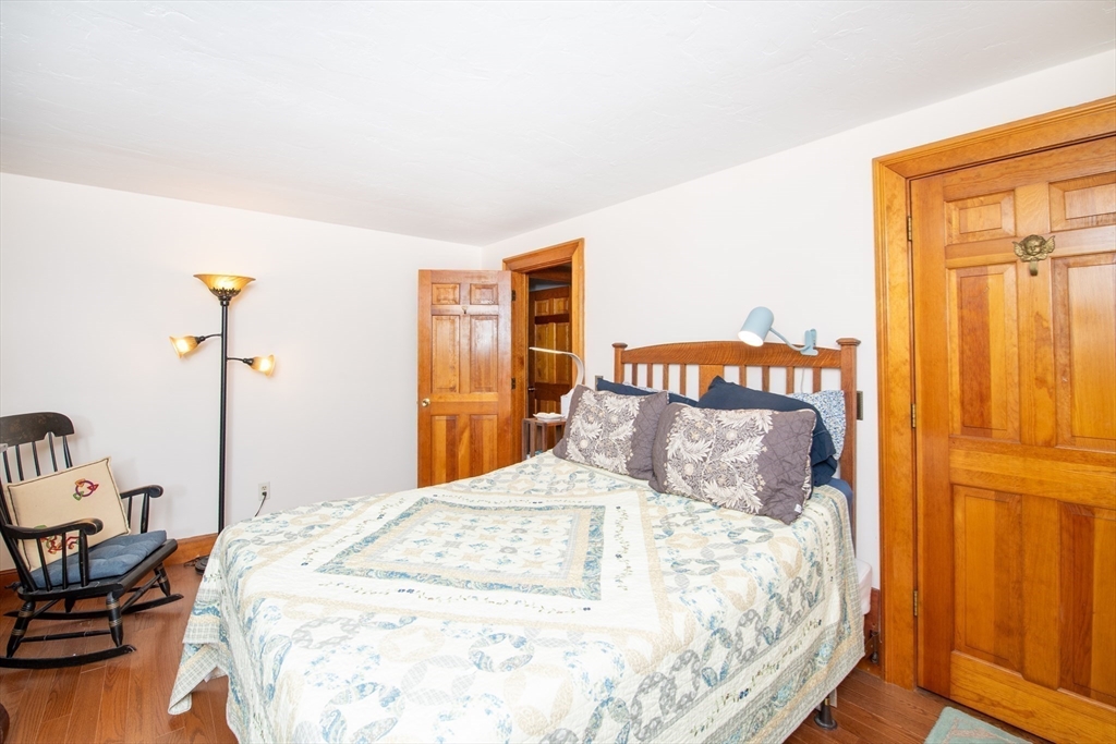 663 Wareham Street, Unit 8 Middleboro, MA 02346 - Photo 16 of 27 a bedroom with a bed and wooden floor