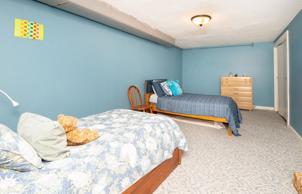 663 Wareham Street, Unit 8 Middleboro, MA 02346 - Photo 19 of 27 a bedroom with a bed and a lamp