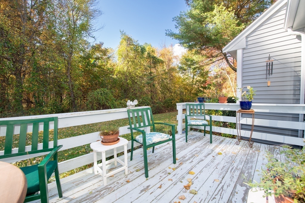 663 Wareham Street, Unit 8 Middleboro, MA 02346 - Photo 25 of 27 a balcony with wooden floor table and chairs