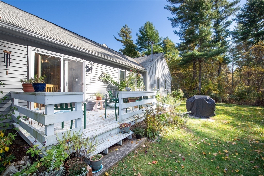 663 Wareham Street, Unit 8 Middleboro, MA 02346 - Photo 27 of 27 a view of a patio with table and chairs potted plants and large tree