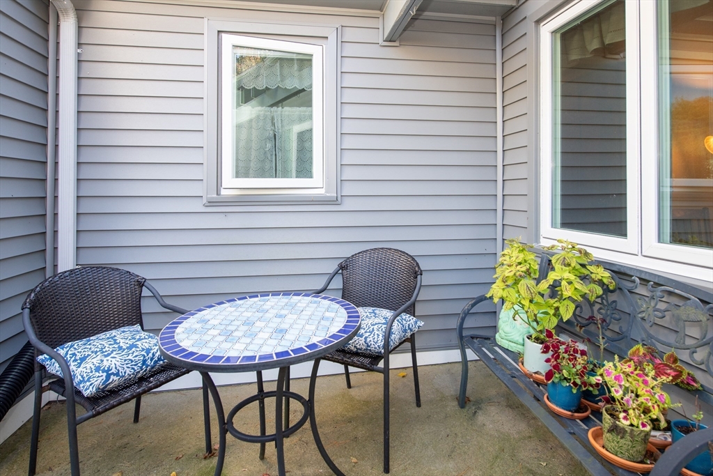 663 Wareham Street, Unit 8 Middleboro, MA 02346 - Photo 3 of 27 a backyard of a house with dining table and chairs