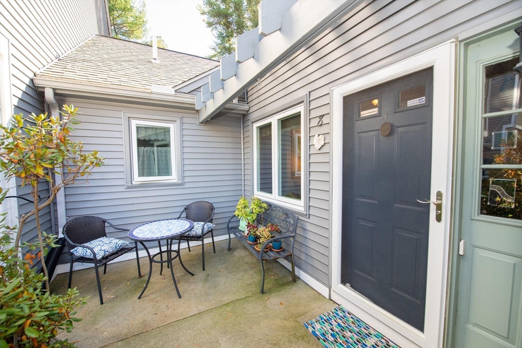 663 Wareham Street, Unit 8 Middleboro, MA 02346 - Photo 4 of 27 a view of a porch with chairs and table in a patio