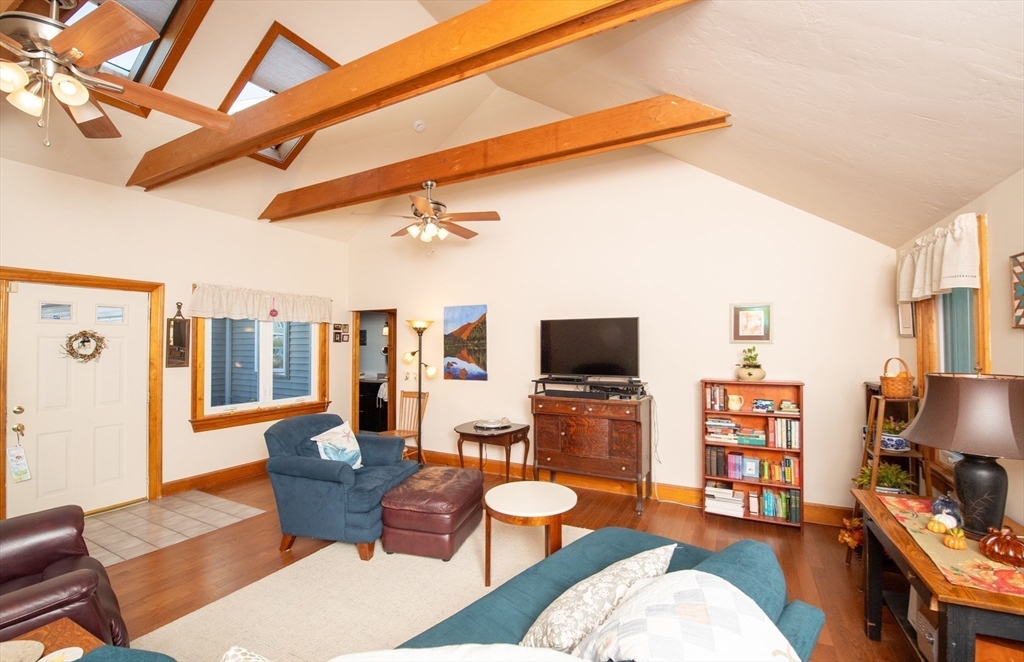 663 Wareham Street, Unit 8 Middleboro, MA 02346 - Photo 5 of 27 a living room with furniture a flat screen tv and a floor to ceiling window