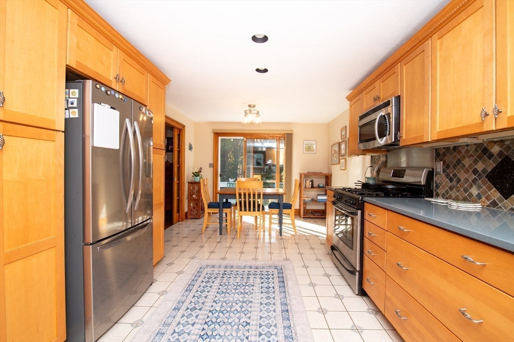 663 Wareham Street, Unit 8 Middleboro, MA 02346 - Photo 9 of 27 a kitchen with stainless steel appliances granite countertop a refrigerator stove microwave and cabinets