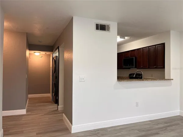a view of kitchen with furniture and wooden floor