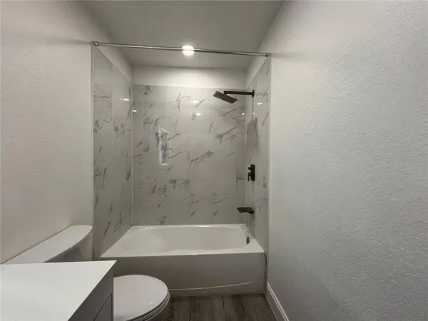 a bathroom with a sink a toilet and bathtub