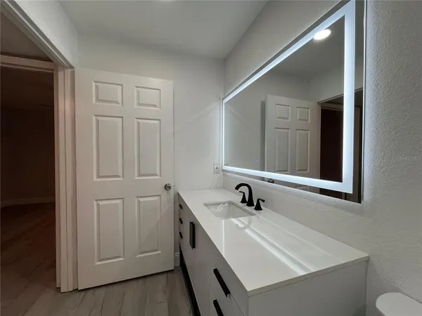 a bathroom with a sink and a mirror