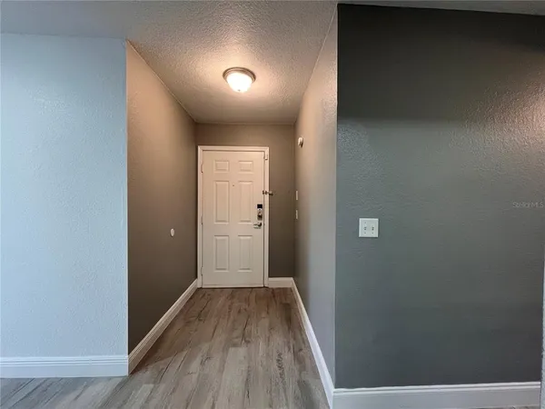 a view of a hallway with wooden floor