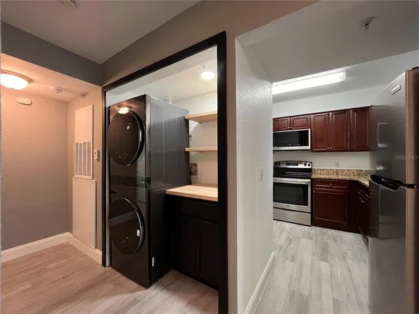 a kitchen with stainless steel appliances granite countertop a refrigerator and a sink