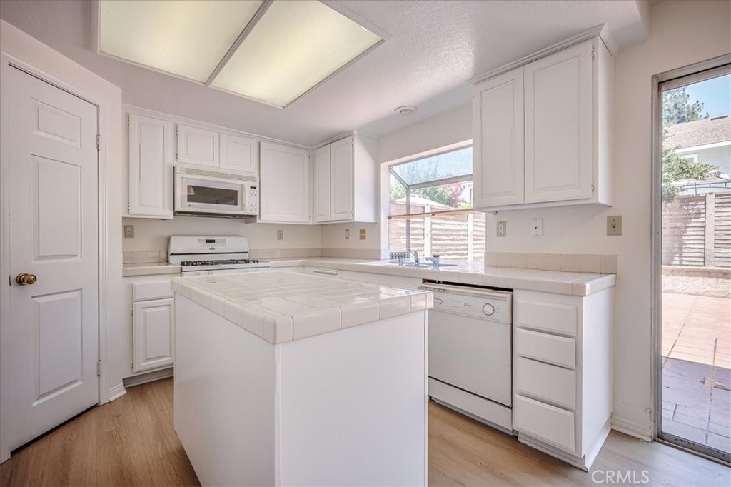 629 Calaveras Road San Dimas, CA 91773 - Photo 19 of 49 a kitchen with cabinets appliances a sink and a window