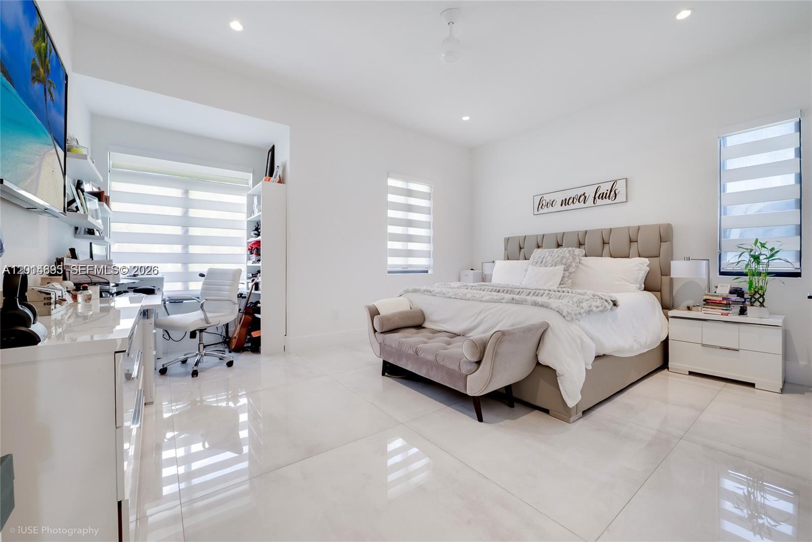 7830 Southwest 117th Street Pinecrest, FL 33156 - Photo 12 of 24 a spacious bedroom with a bed and a couch