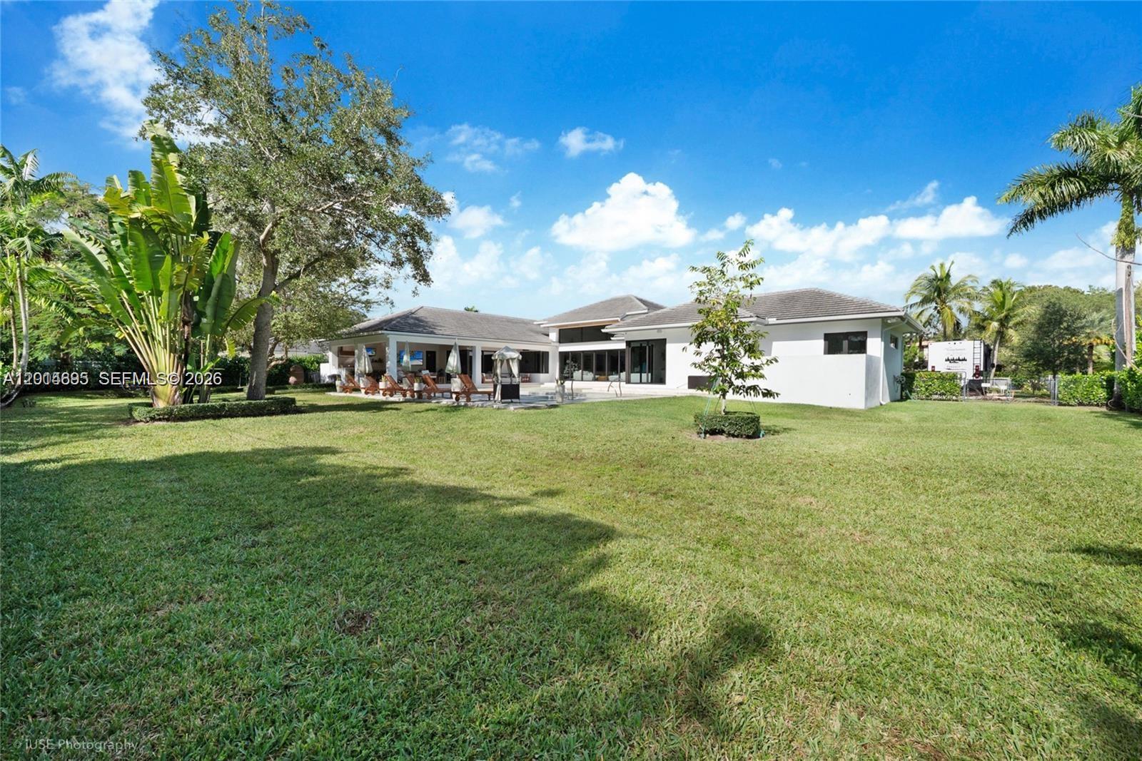 7830 Southwest 117th Street Pinecrest, FL 33156 - Photo 23 of 24 a front view of house with yard