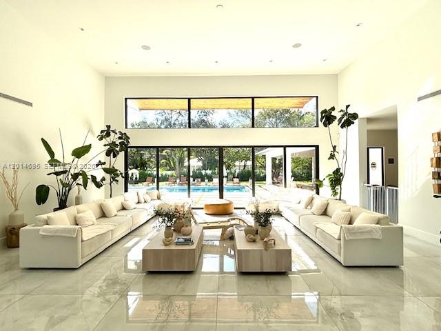 7830 Southwest 117th Street Pinecrest, FL 33156 - Photo 6 of 24 a living room with furniture and large windows