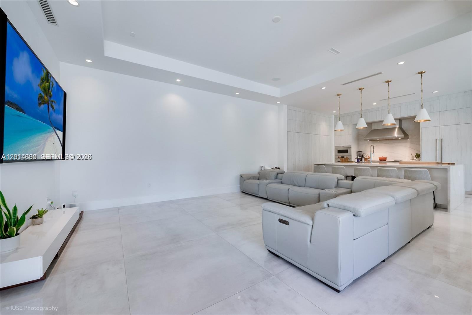 7830 Southwest 117th Street Pinecrest, FL 33156 - Photo 7 of 24 a living room with furniture and kitchen view