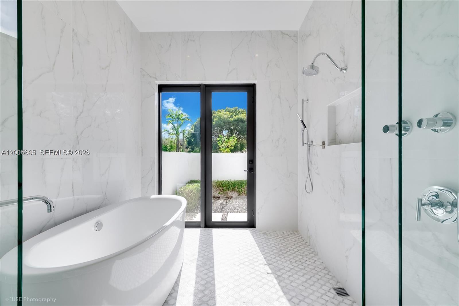 7830 Southwest 117th Street Pinecrest, FL 33156 - Photo 10 of 24 a bathroom with a tub and a shower