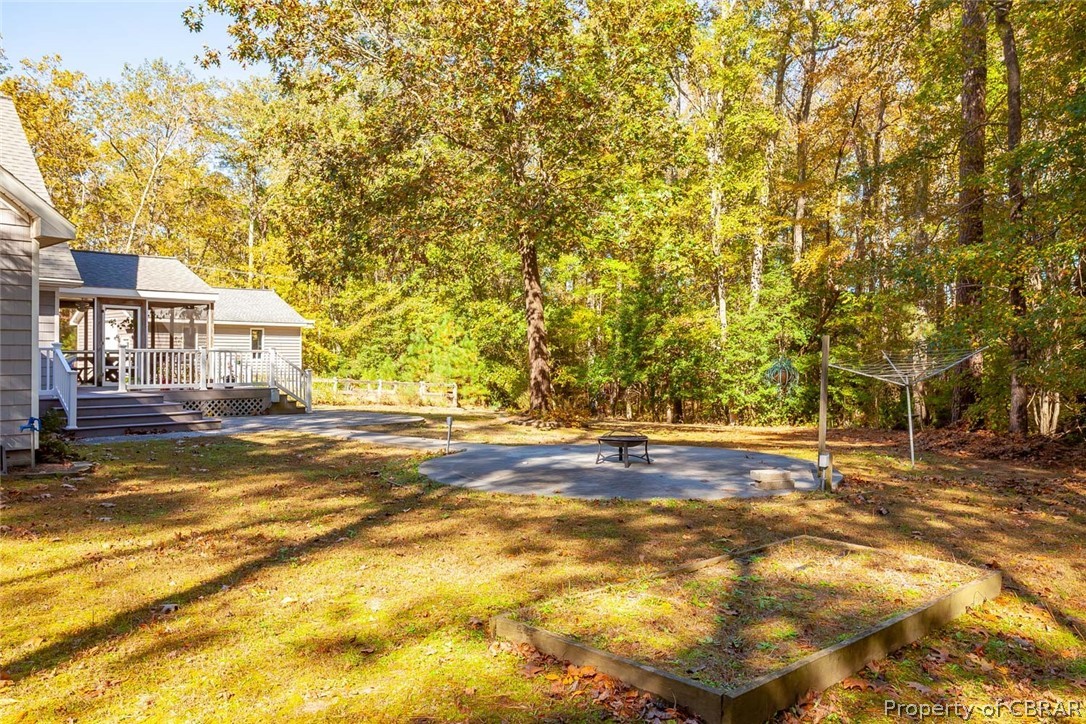 142 Sawmill Road White Stone, VA 22578 - Photo 4 of 38 Walkway from the deck to the cement pad, perfect place for a fire pit or an above ground pool.