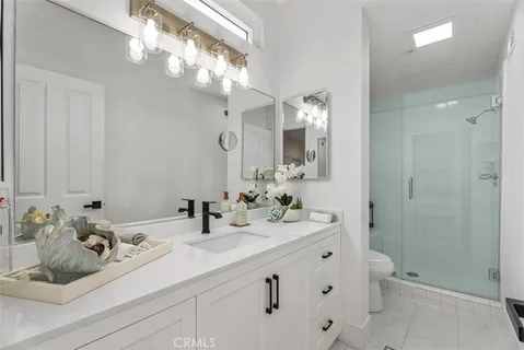 a bathroom with a sink double vanity and a mirror