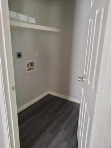 a view of a room with wooden floor and white walls