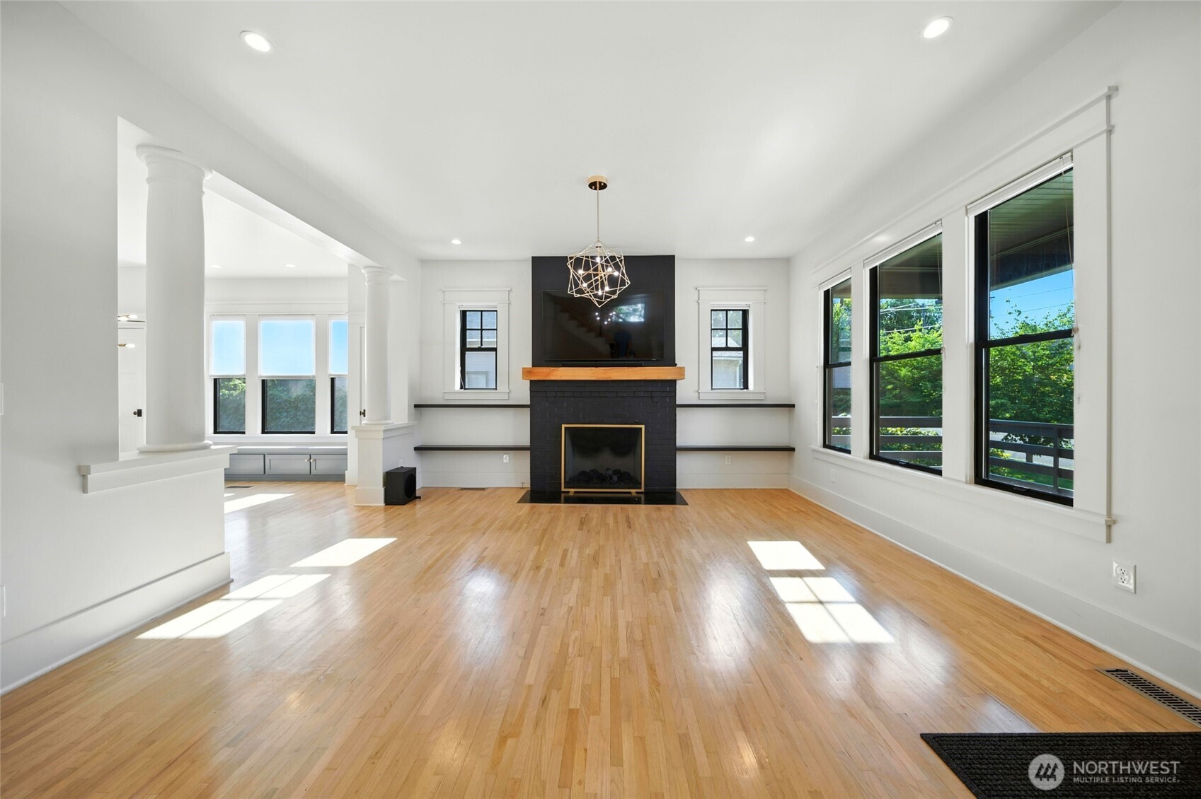 531 Newell Street Walla Walla, WA 99362 - Photo 8 of 38 an empty room with windows fireplace and wooden floor