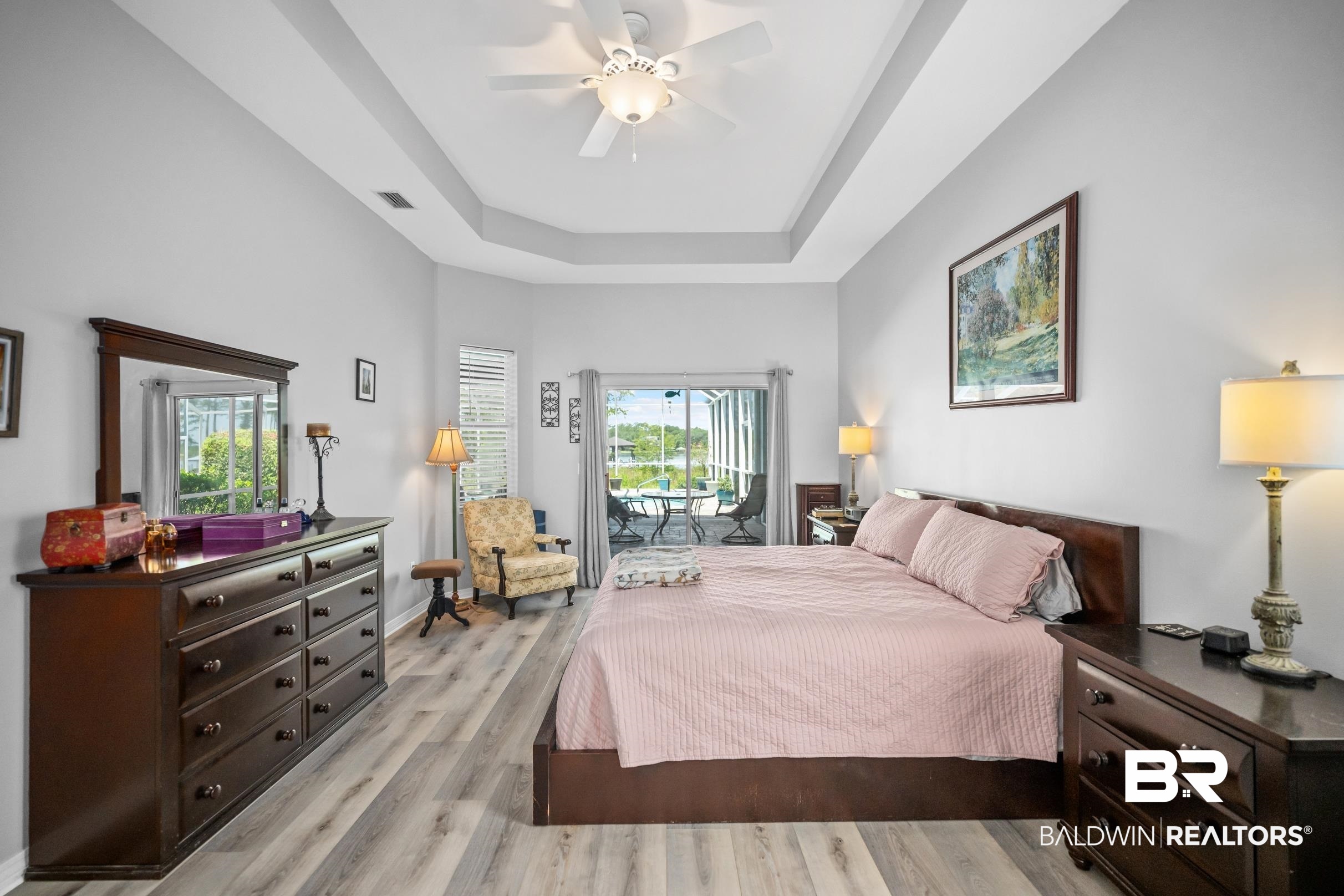 8585 Bay Harbor Road Elberta, AL 36530 - Photo 22 of 51 Bedroom with access to exterior, a raised ceiling, light wood finished floors, and a ceiling fan