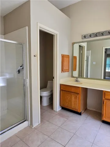 a spacious bathroom with a granite countertop sink and a mirror