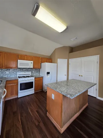 a kitchen with stainless steel appliances granite countertop a stove top oven and sink