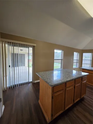 a kitchen with wooden floors and wooden cabinets