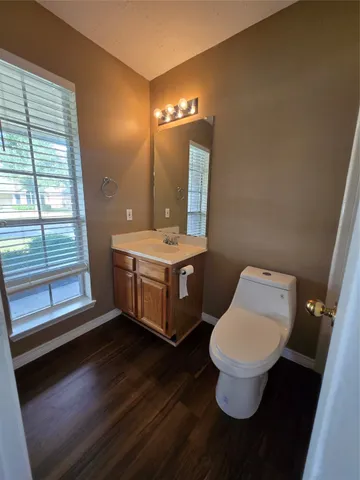 a room with a toilet a sink and a mirror