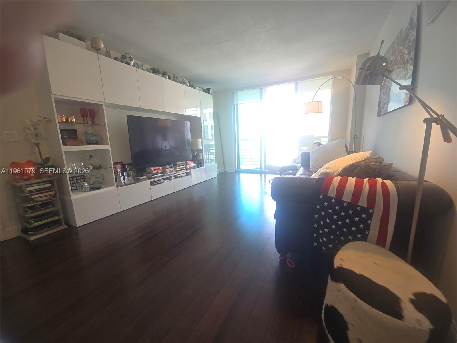 335 South Biscayne Boulevard, Unit 3400 Miami, FL 33131 - Photo 15 of 52 a living room with furniture and a flat screen tv