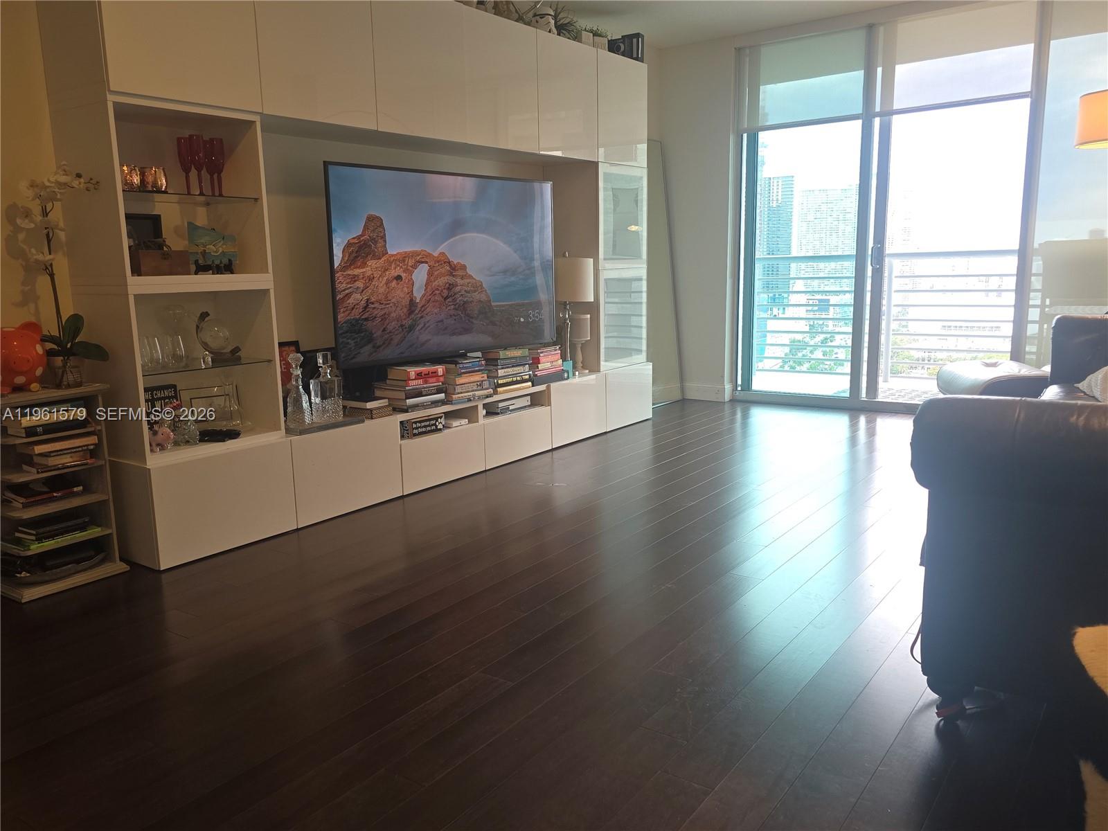 335 South Biscayne Boulevard, Unit 3400 Miami, FL 33131 - Photo 16 of 52 a view of a livingroom with furniture wooden floor and a window