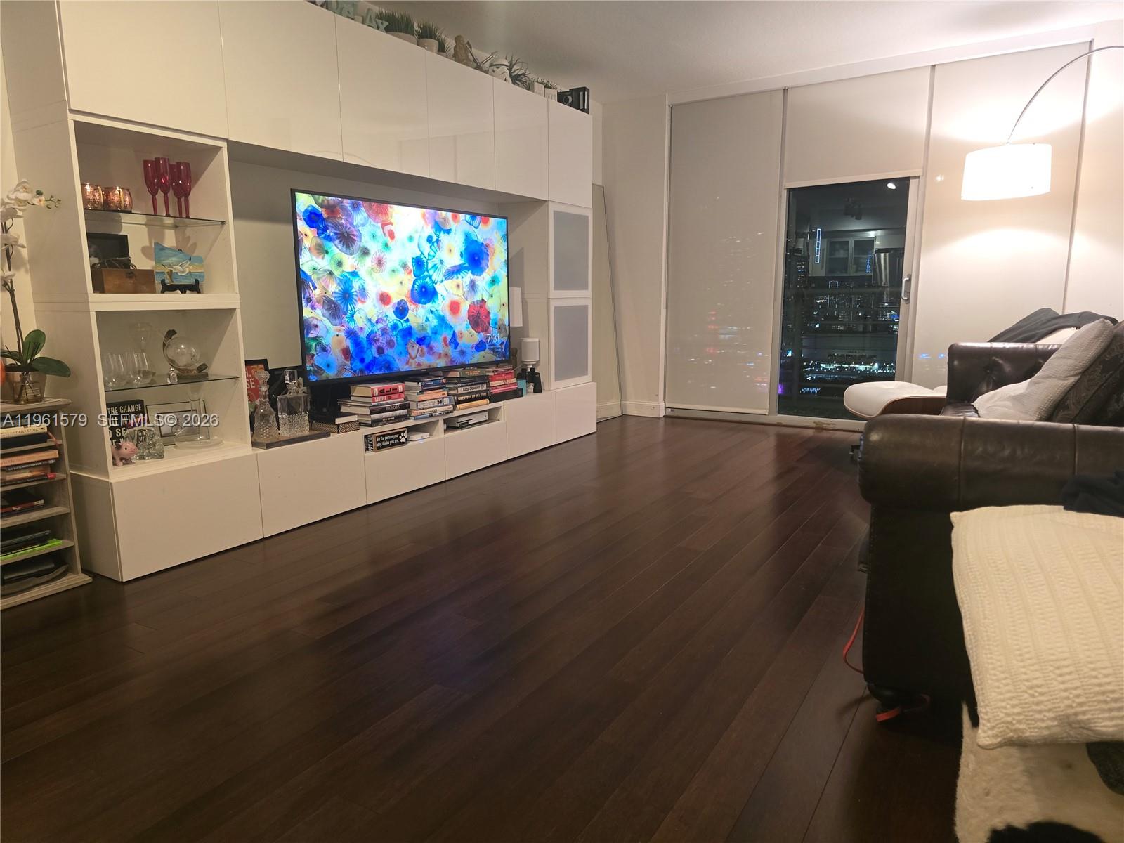 335 South Biscayne Boulevard, Unit 3400 Miami, FL 33131 - Photo 18 of 52 a living room with furniture flat screen tv and wooden floor