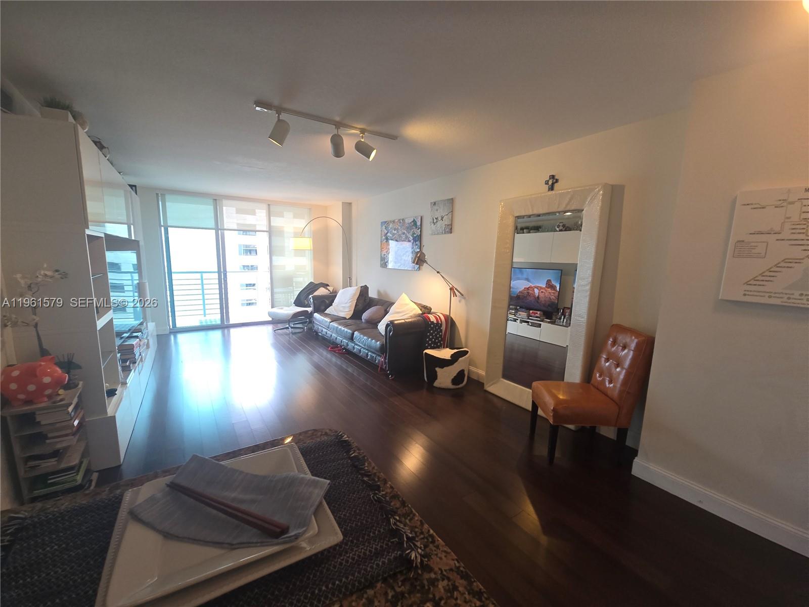 335 South Biscayne Boulevard, Unit 3400 Miami, FL 33131 - Photo 19 of 52 a living room with furniture and a chandelier