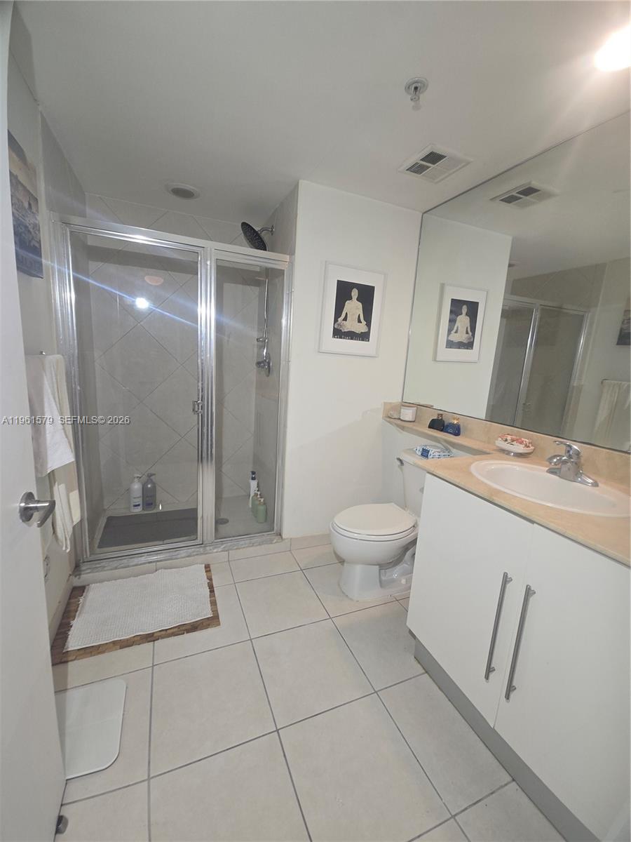 335 South Biscayne Boulevard, Unit 3400 Miami, FL 33131 - Photo 25 of 52 a bathroom with a sink a toilet and a mirror