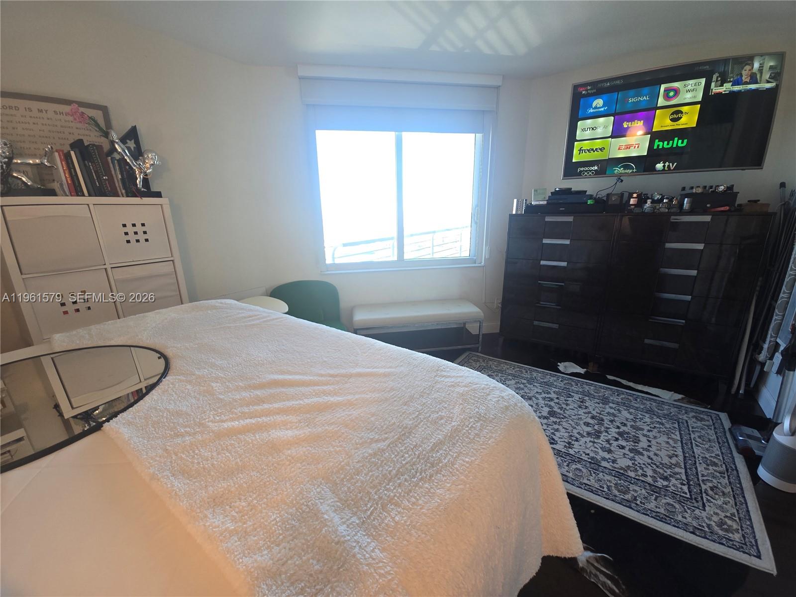 335 South Biscayne Boulevard, Unit 3400 Miami, FL 33131 - Photo 27 of 52 a bedroom with a bed and flat screen tv