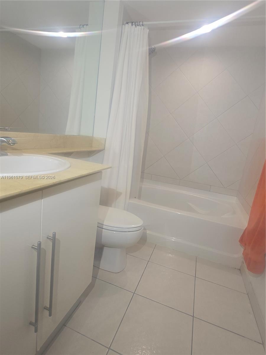 335 South Biscayne Boulevard, Unit 3400 Miami, FL 33131 - Photo 33 of 52 a bathroom with a granite countertop sink a toilet and shower