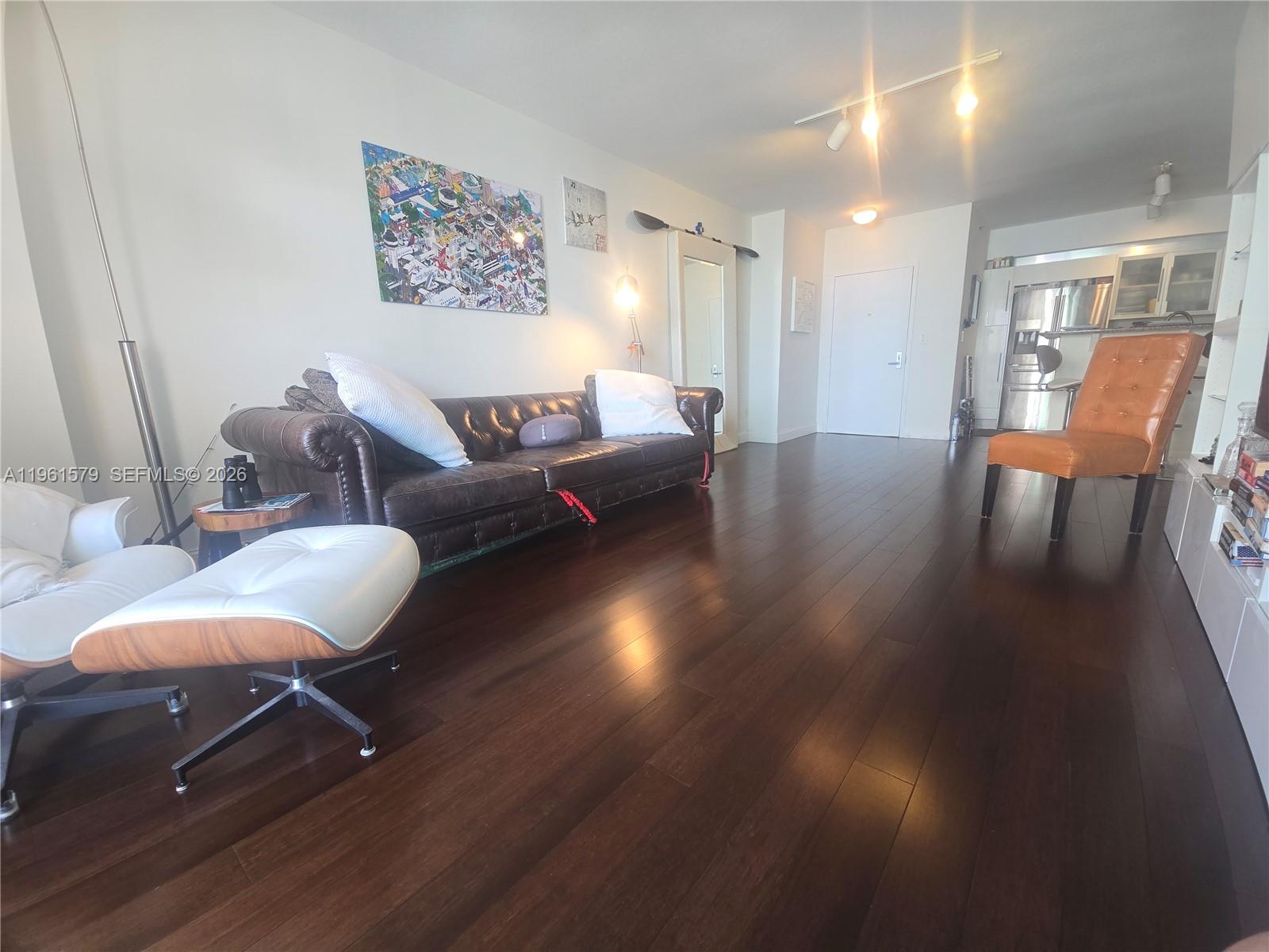 335 South Biscayne Boulevard, Unit 3400 Miami, FL 33131 - Photo 6 of 52 a living room with furniture and wooden floor