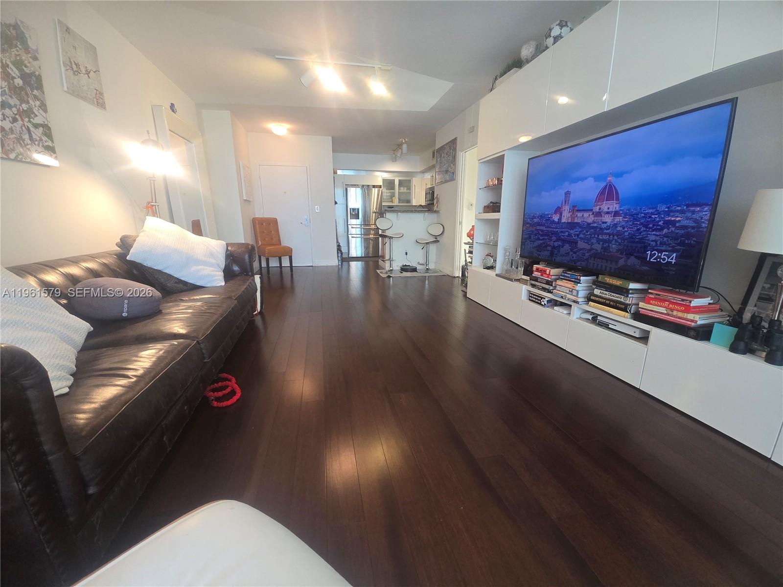335 South Biscayne Boulevard, Unit 3400 Miami, FL 33131 - Photo 8 of 52 a living room with furniture and a flat screen tv