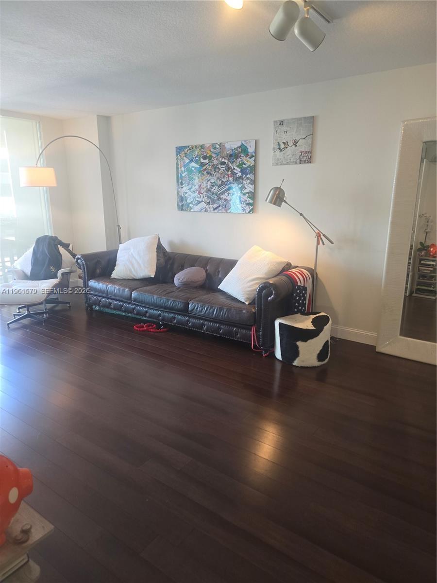 335 South Biscayne Boulevard, Unit 3400 Miami, FL 33131 - Photo 9 of 52 a living room with furniture and wooden floor