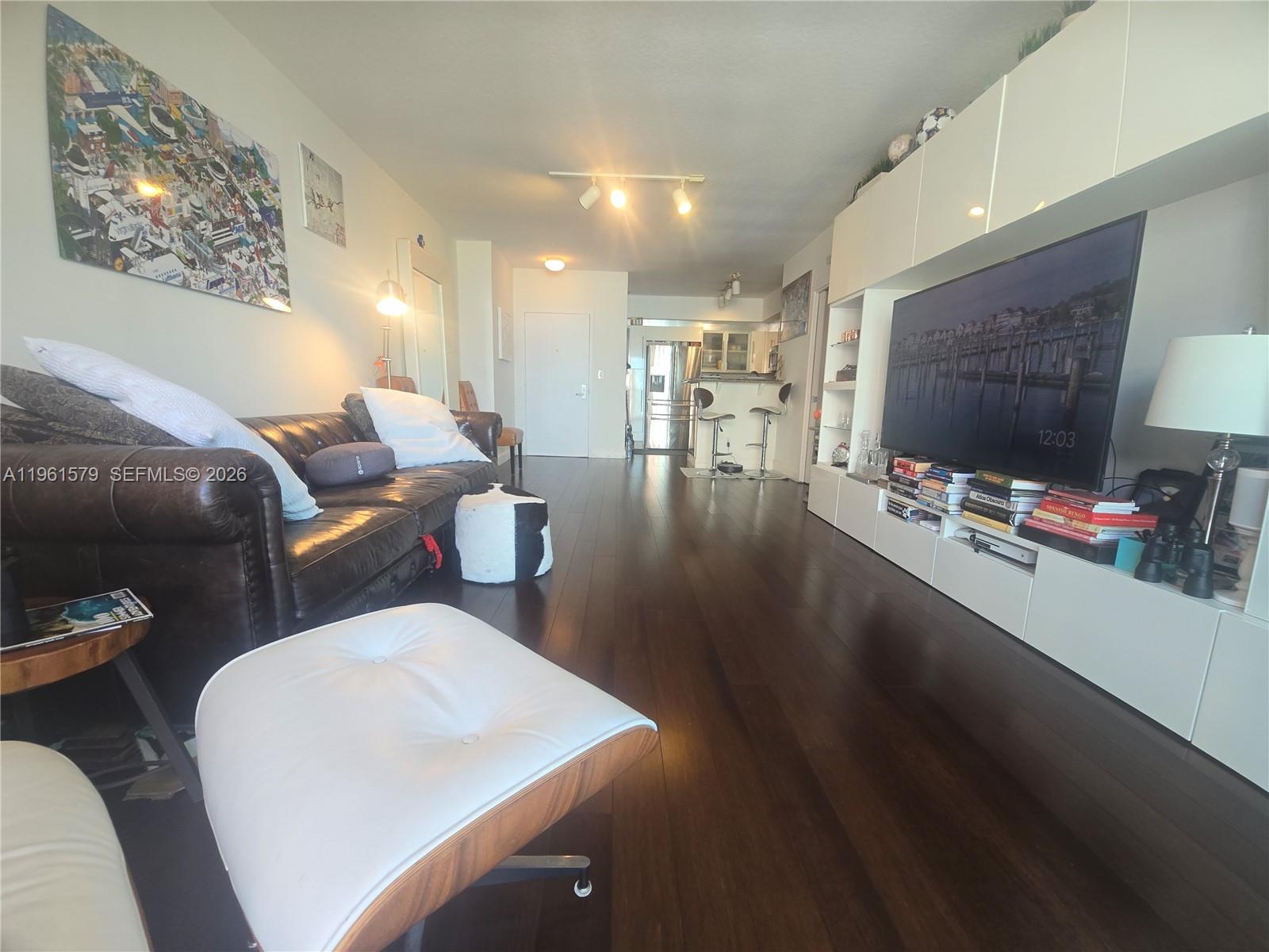 335 South Biscayne Boulevard, Unit 3400 Miami, FL 33131 - Photo 10 of 52 a living room with furniture and a flat screen tv